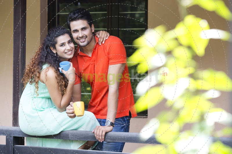 couple drinking coffee at balcony