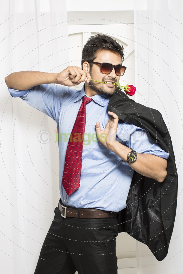 man with rose in his mouth 