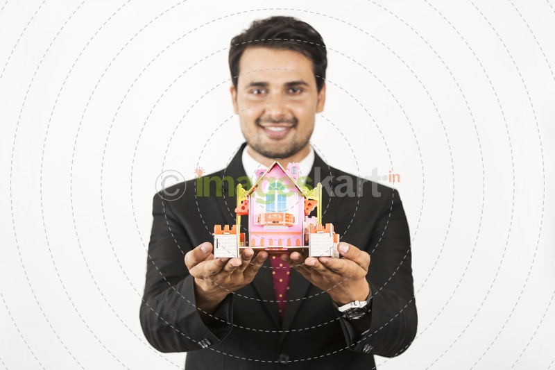 real estate agent showing home miniature 