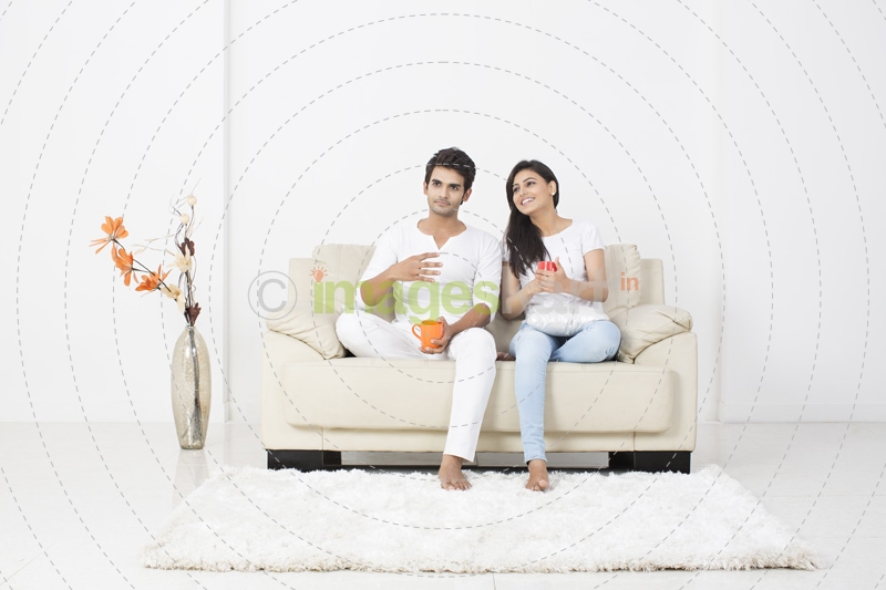 couple on couch having coffee