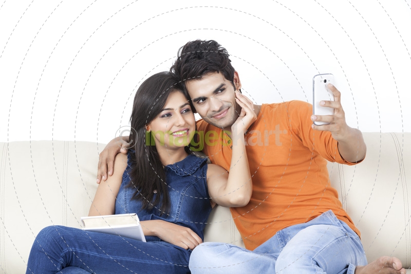couple taking picture with mobile phone
