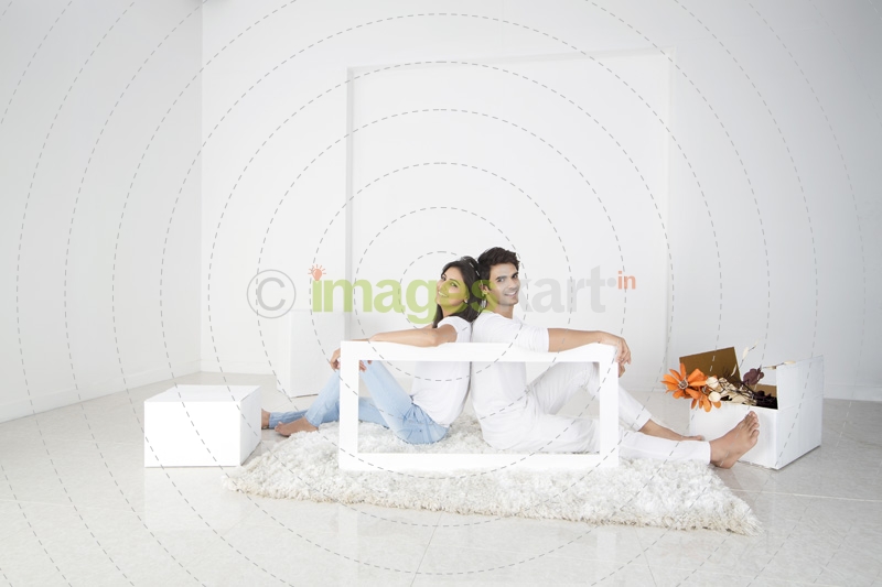 couple posing with frame