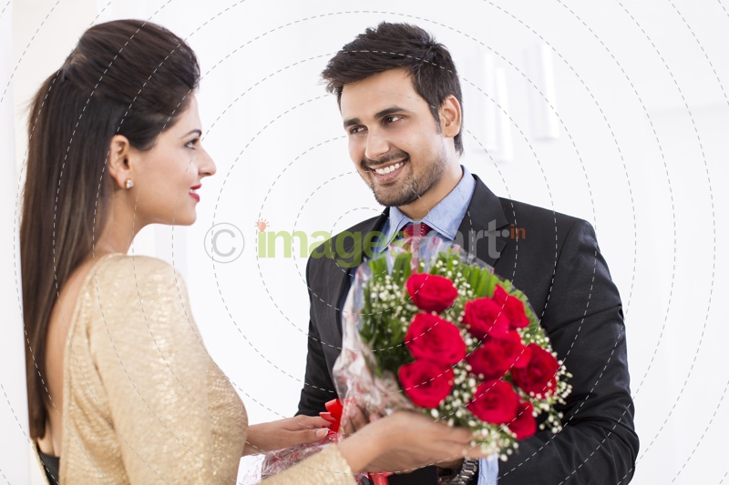 man proposing girl with bouquet 