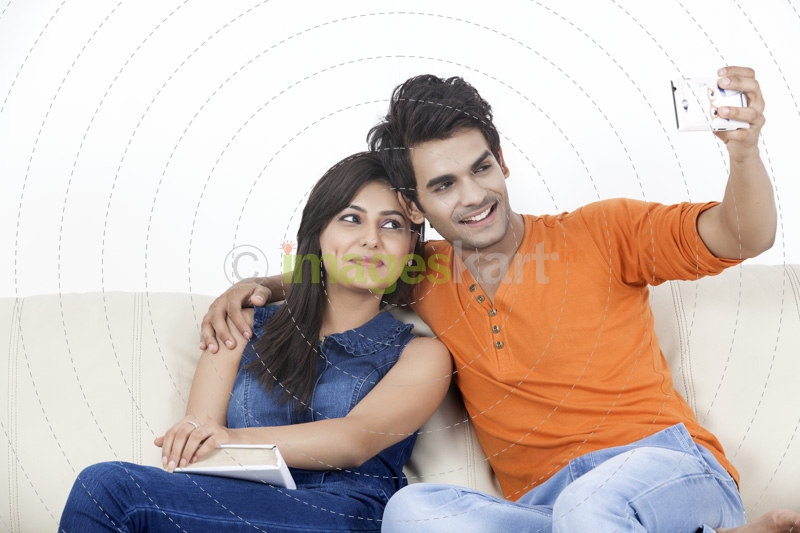 couple smiling while taking selfie