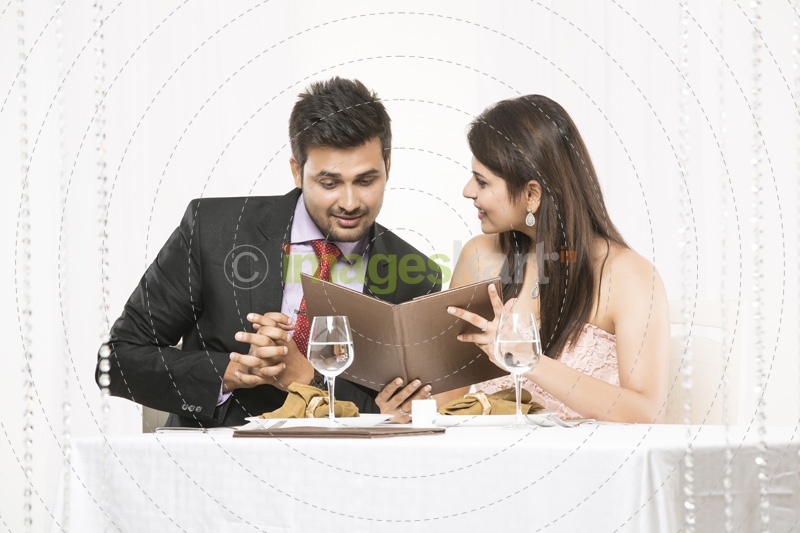 couple looking at the menu and smiling 