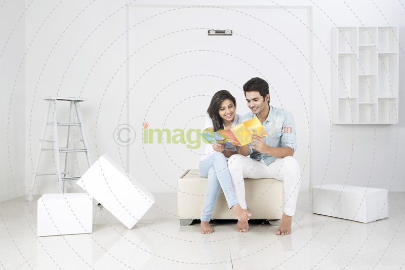 couple in new home deciding wall paint colour