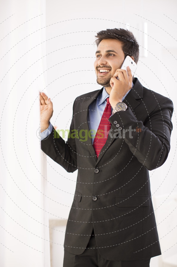 man in formals talking on phone