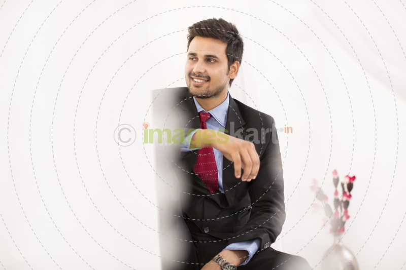 businessman in suit smiling and posing 