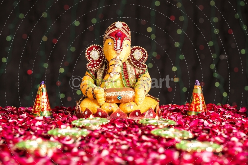 lord ganesha idol with diyas and crackers