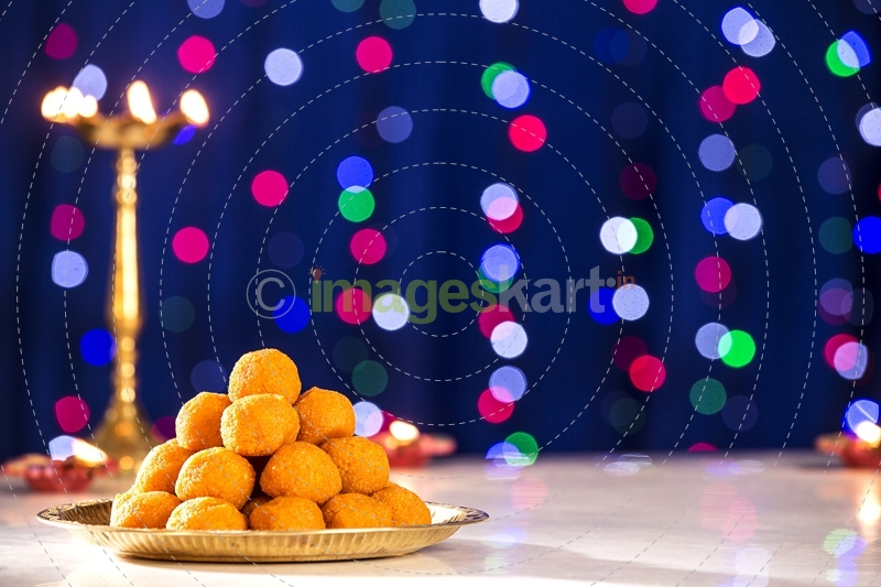 lighting lamps and ladoo on diwali 