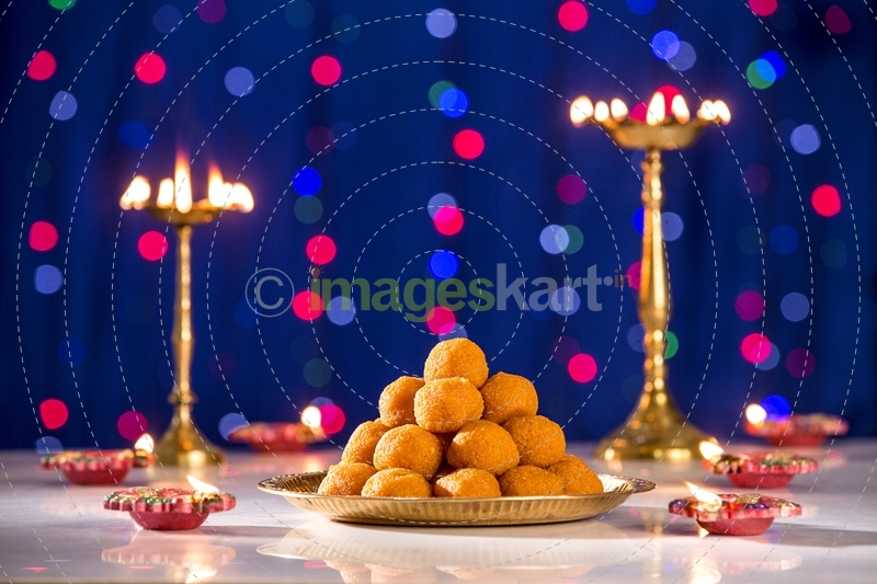 lighting lamps and ladoo on diwali 