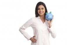 woman in a pink shirt posing with a blue piggy bank