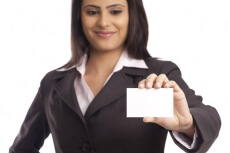 smiling corporate lady handing a business card