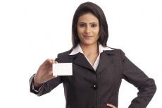 smiling corporate lady handing a business card