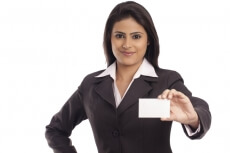 smiling corporate lady handing a business card