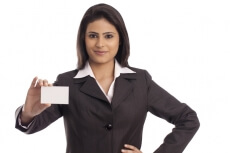 smiling corporate lady handing a business card