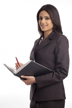 female executive carrying a diary and pen