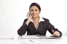 woman looking at the camera and talking on the phone