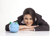 smiling young business woman with a blue piggy bank