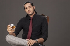 man drinking and looking at the camera 
