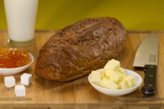 fresh brown bread with butter and jelly