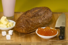 bread,butter,jam and sugar cubes on a wooden table