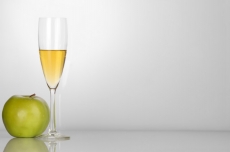 champagne glass with white background and green apple