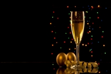 champagne glass with black background and decorative balls