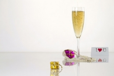 picture of a flute wine glass along with gifts,love note and copy spac