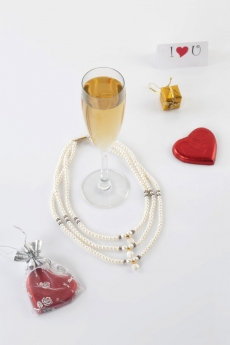 love note with a glass full of champagne and gifts 