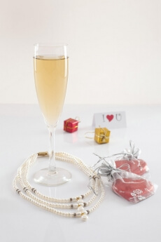 close up shot of a flute glass full of champagne on white background