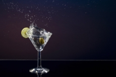 dropping olive in a martini