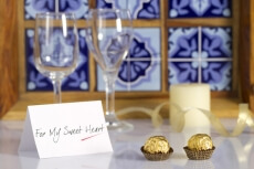 wine glasses and chocolates with love note