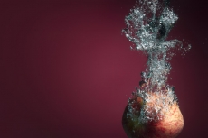 apple sinking in water and forming water waves