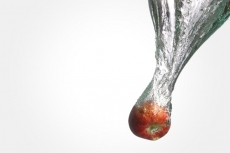 an apple falling into fresh water