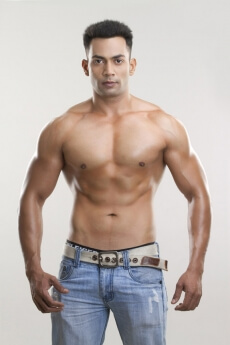 man posing shirtless in his jeans