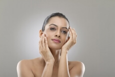 girl applying skin product on the face