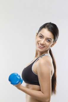 attractive girl lifting dumbbells