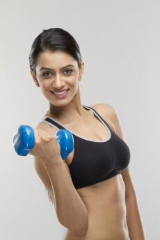 attractive girl lifting dumbbells