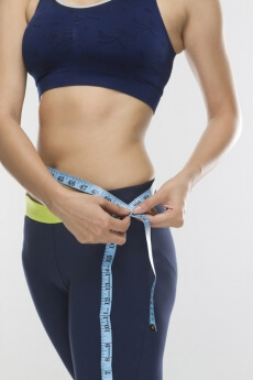 lose up of a girl measuring waist