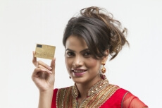 portrait of young woman holding credit card