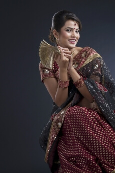 indian woman with stack of notes