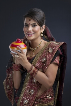 woman saving money in an Indian piggy-bank