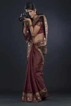 woman in an indian saree taking a picture