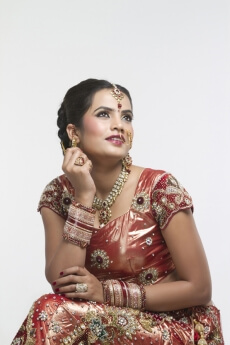 indian bride in bridal wear looking away