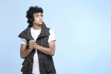 young boy wearing half jacket and posing