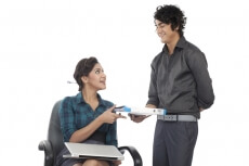 working man giving files working woman 