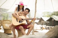 guy playing guitar for his girlfriend