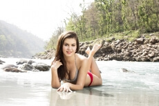 attractive girl in bikini lying on the seashore