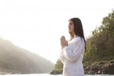 woman with folded hands with a view of the mountains
